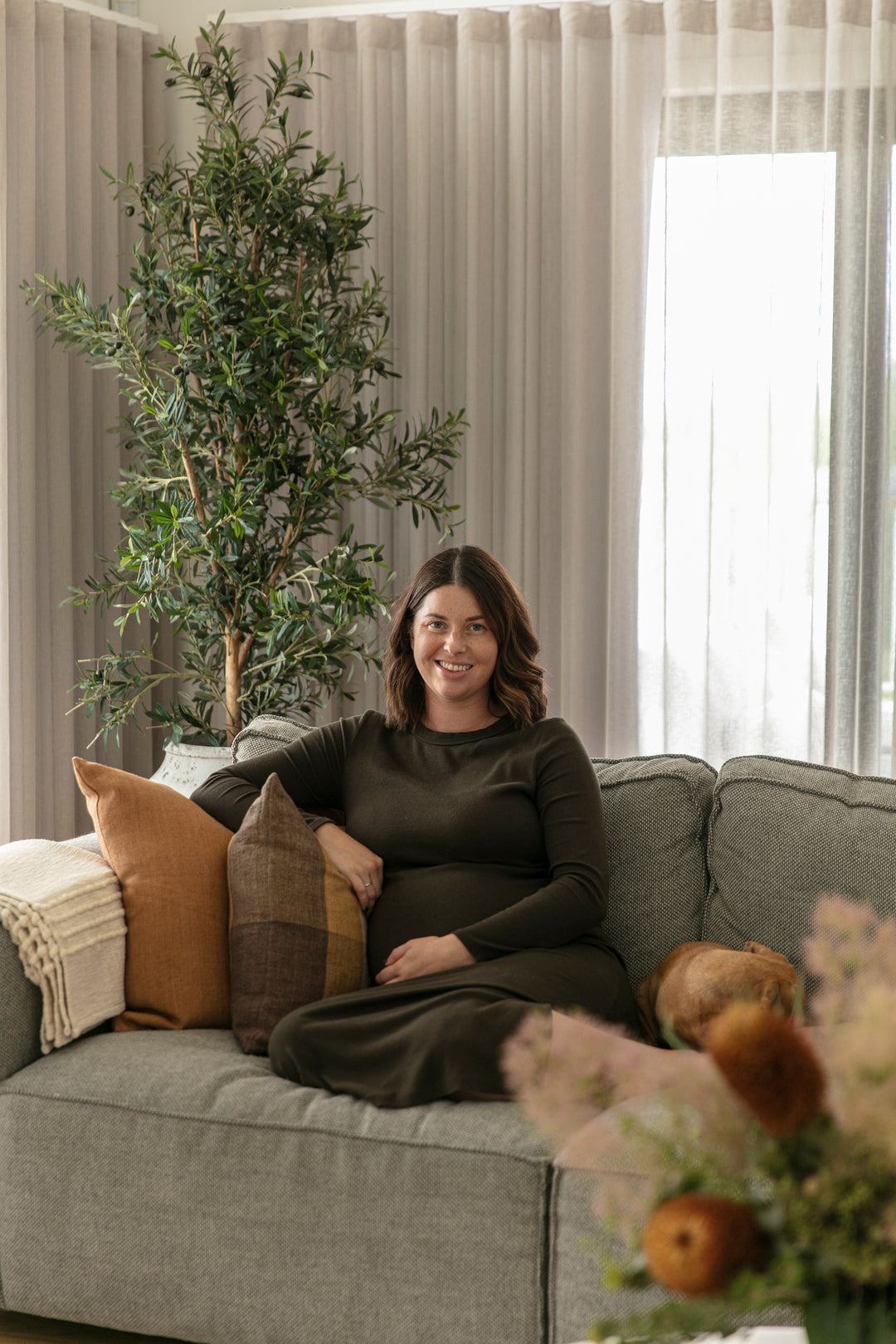 Tayah Mann the owner of Maison on Main sitting on a couch