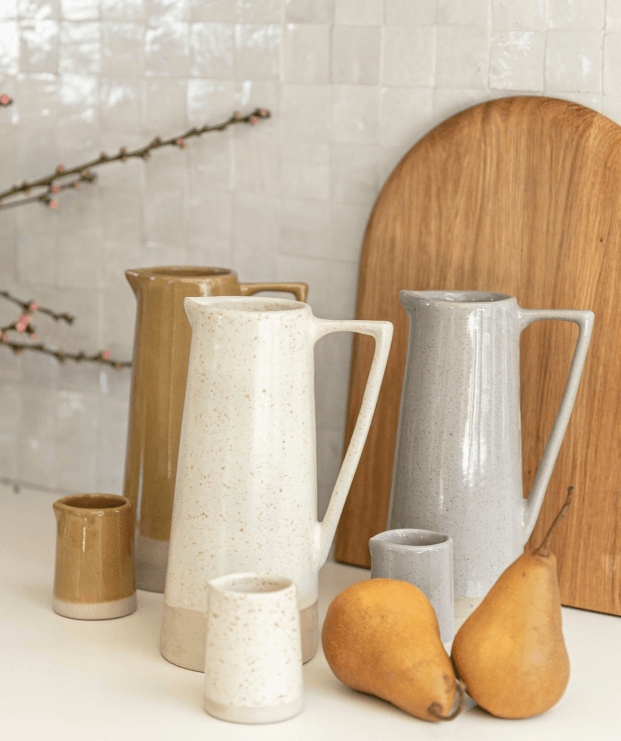 A selection of ceramic vases on a kitchen bench