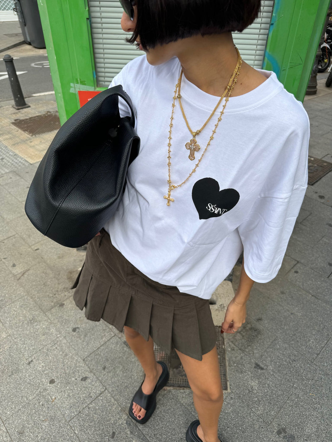 Lady wearing a white tee with a black heart 